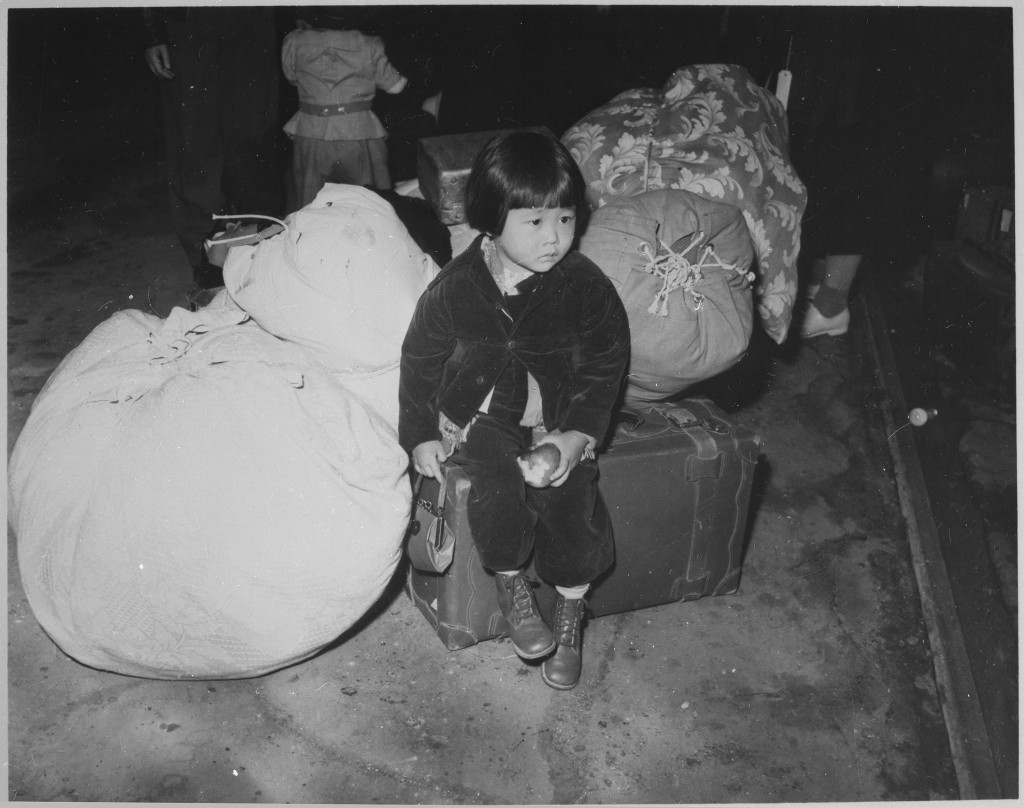 http://en.wikipedia.org/wiki/Internment_of_Japanese_Americans#mediaviewer/File:A_young_evacuee_of_Japanese_ancestry_waits_with_the_family_baggage_before_leaving_by_bus_for_an_assembly_center..._-_NARA_-_539959.jpg