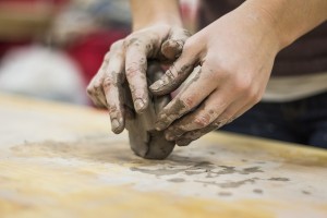 a pair of hands shaping clay