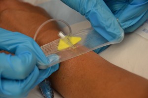 Completely remove dressing from IV site.