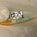 Open sterile catheterization kit and add supplies as necessary