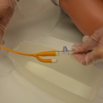 Connect urinary bag to catheter using sterile technique