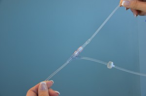 Insert secondary IV tubing into primary IV tubing port