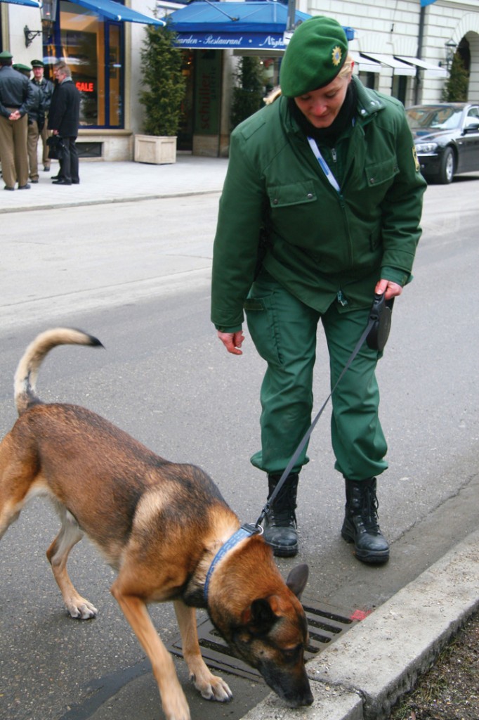 Police officer with a sniffer dog.