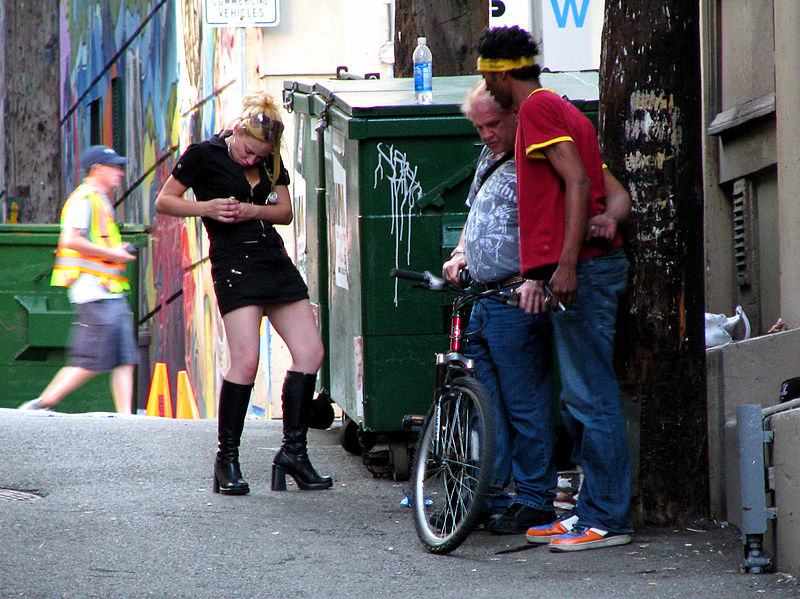 Three drug addicts seen smoking a huge amount of crack cocaine, in a downtown eastside alley, in Vancouver BC Canada