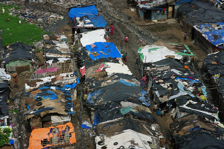 Dilapidated slum dwellings are shown from above.