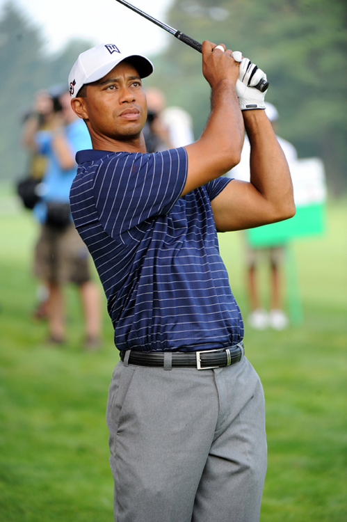 A photo of golfer Tiger Woods just after hitting a ball.
