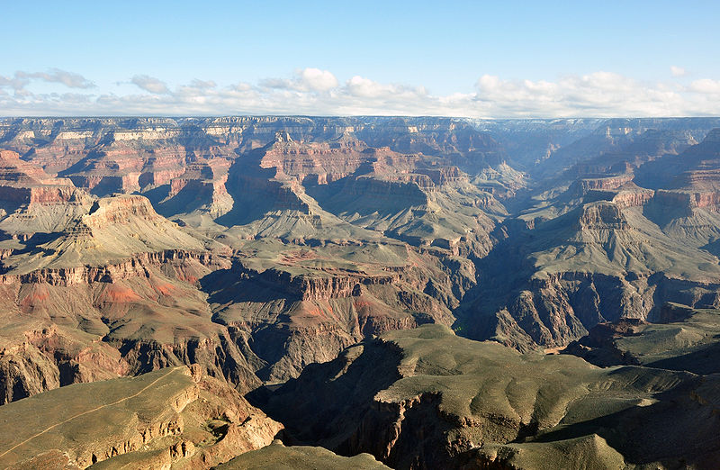 The Grand Canyon was formed by water running through rock for billions of years, very slowly dissolving it. Note the Colorado River is still present in the lower part of the photo. “Grand canyon yavapal point 2010′′ by chensiyuan is licensed under Creative Commons
