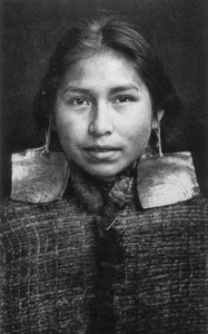 U’magalis (Margaret Wilson Frank) a Kwagu’ł woman photographed early in the twentieth century. Her abalone shell earrings indicate her noble status. (Photo: Edward S. Curtis ca. 1914)