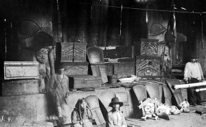 For two years after his death, Haida leader Skowl's body lay in state, surrounded by evidence of his wealth, including coppers (shields) and his slaves. (Photo by Albert P. Niblack, 1883)