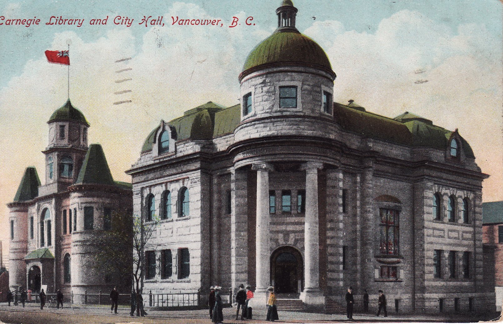 Postcard of two grand stone buildings. One has the Red Ensign flying from the roof.