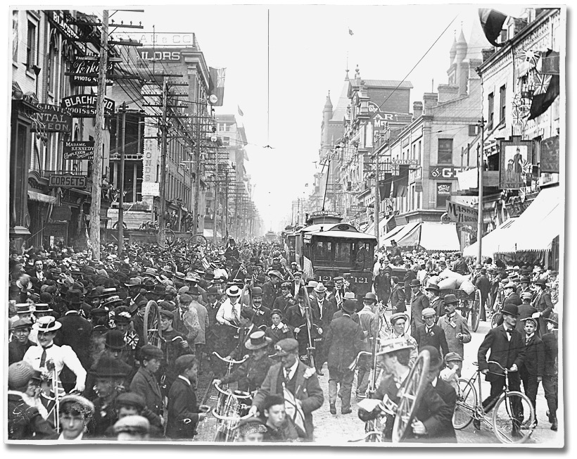 A city street crowded with people.