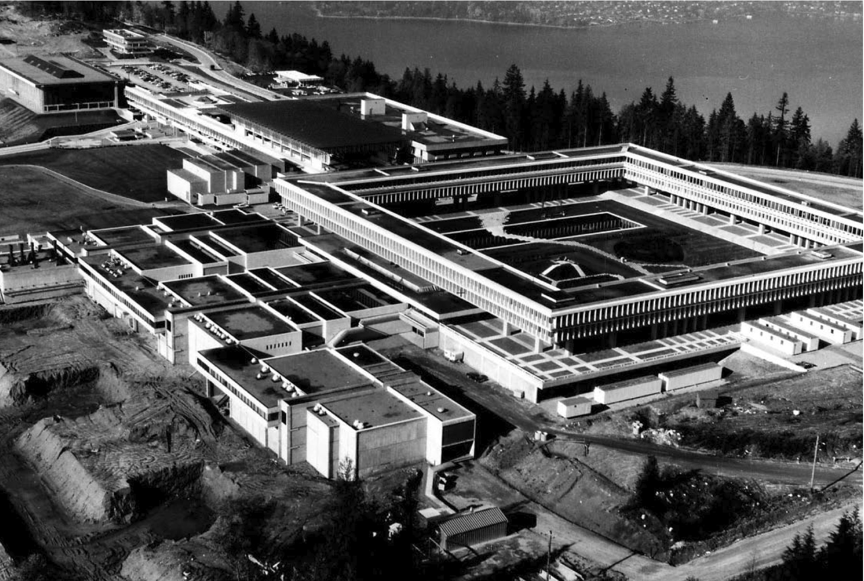 Aerial view of a university. A quad surrounded by a stone building is visible.