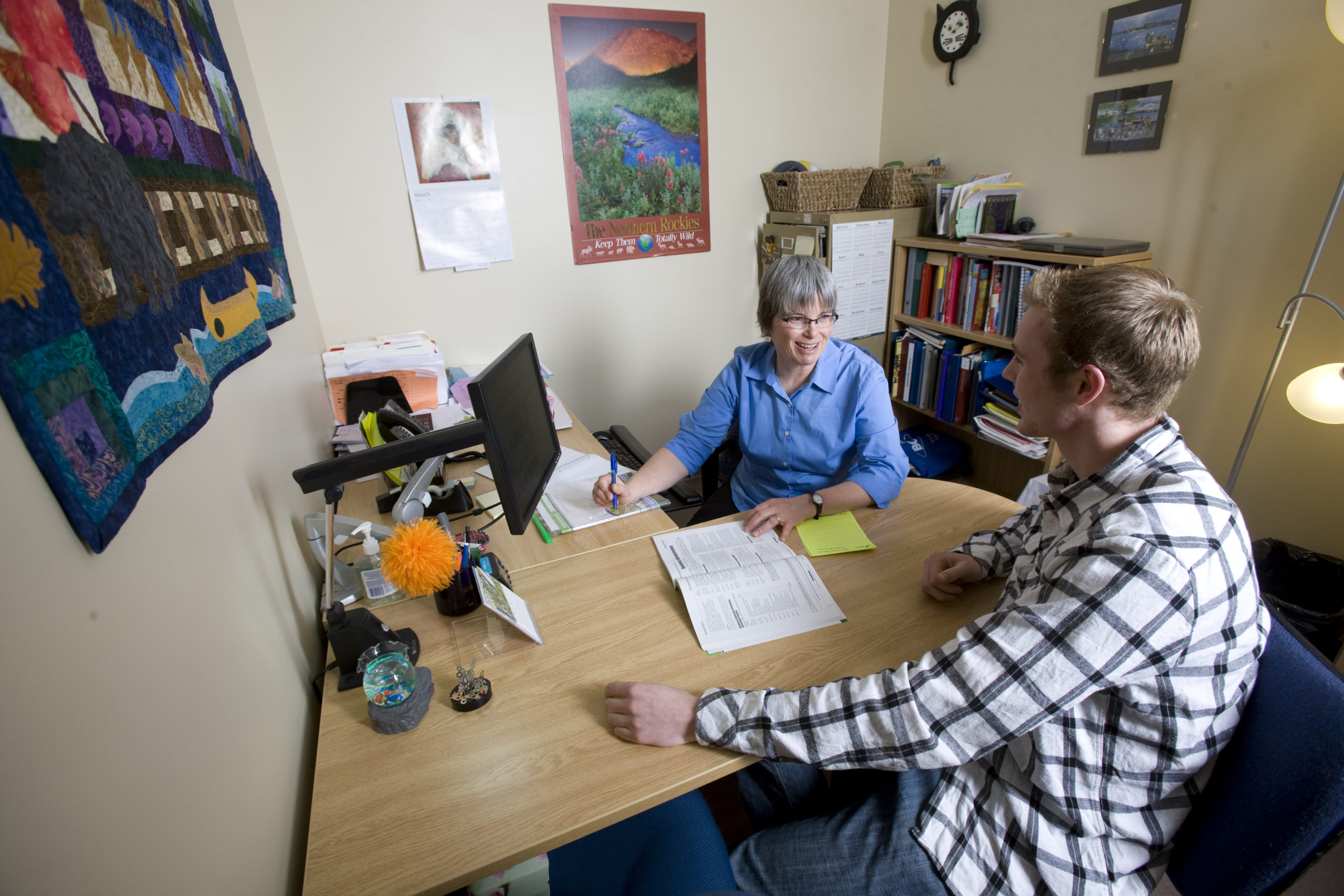 An education advisor at College of the Rockies works with a student