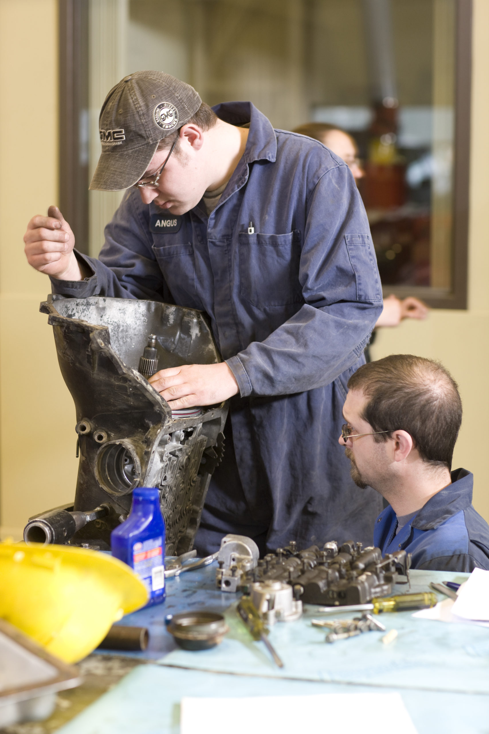 Two mechanics work on a machine