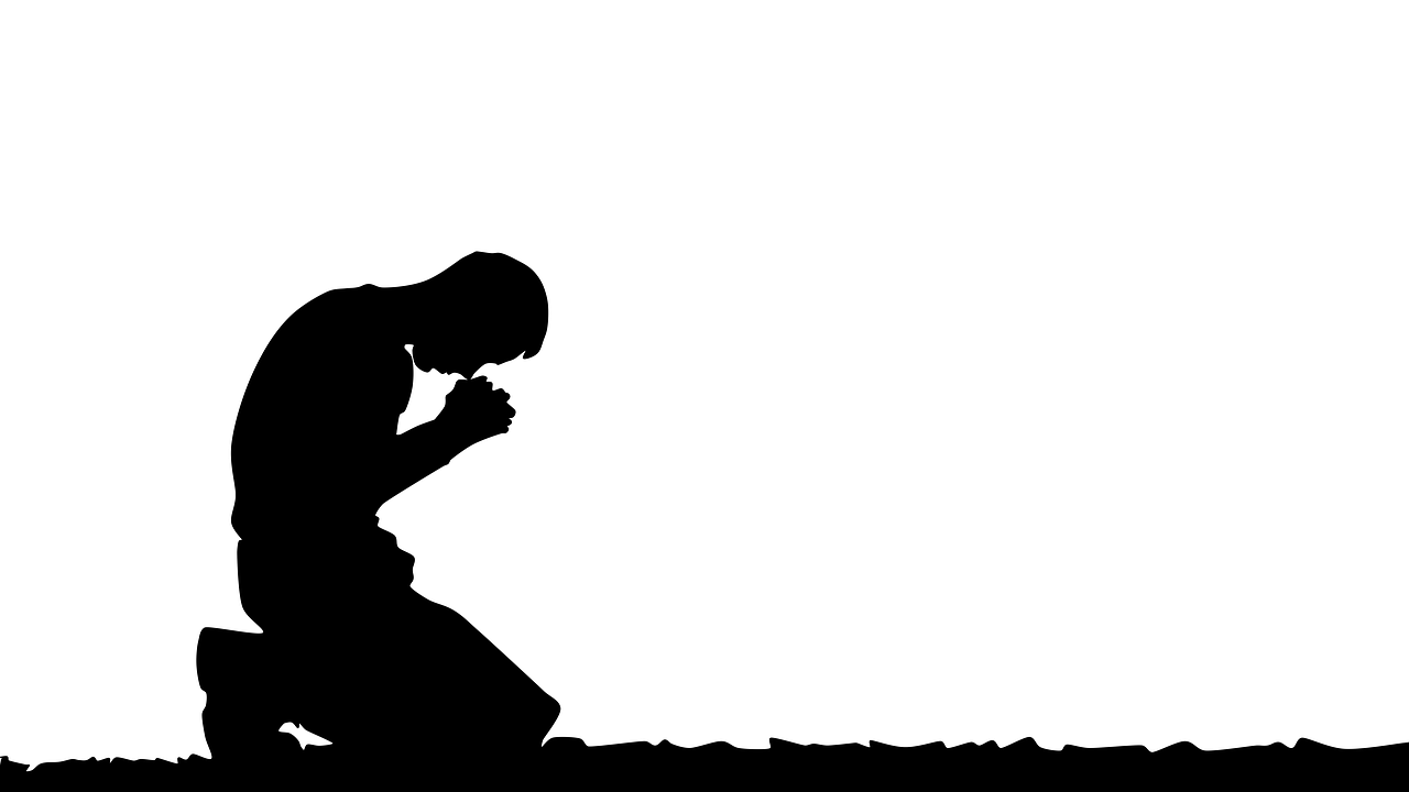 A person on their knees praying