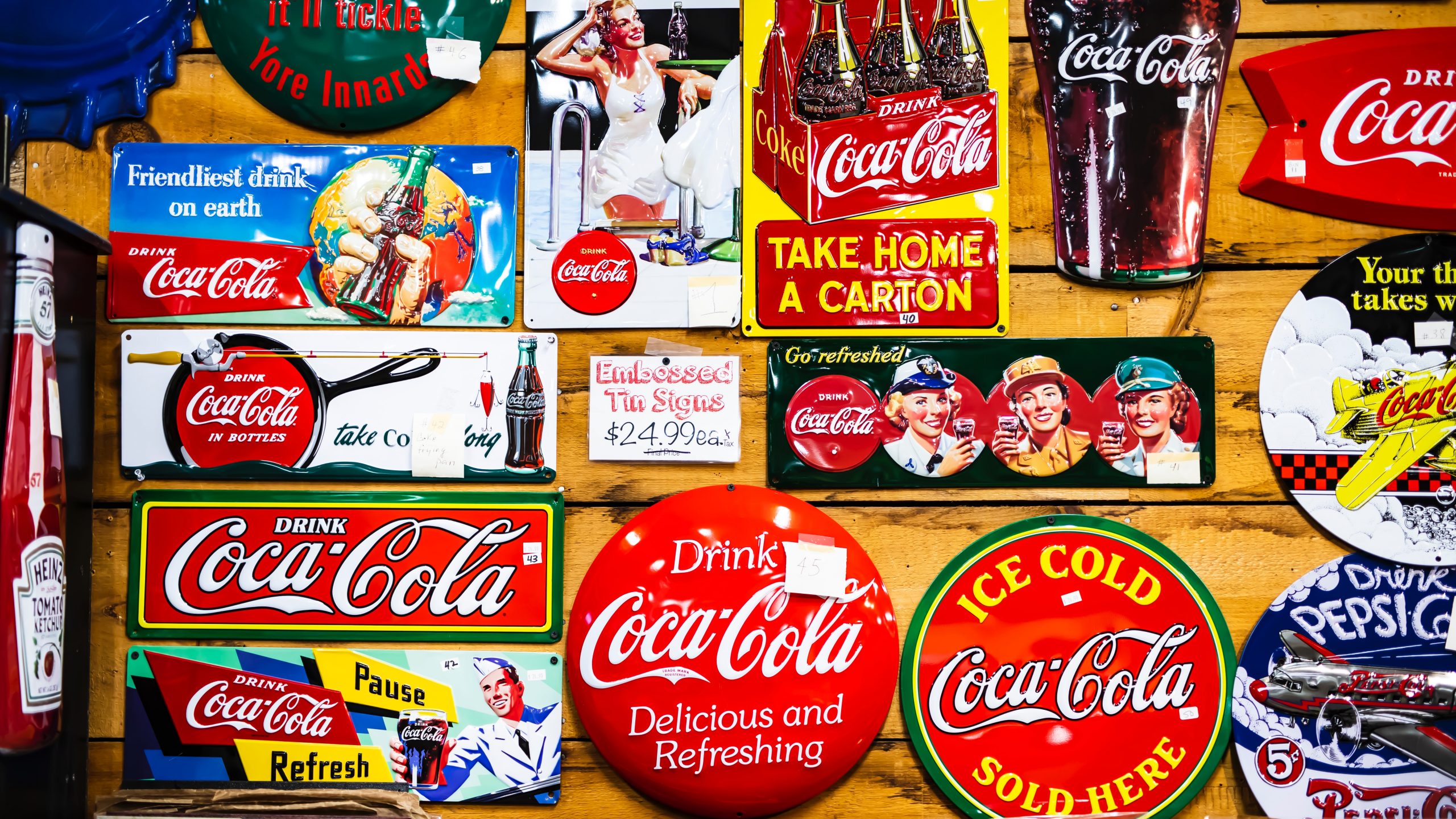 Collage featuring vintage Coca-Cola logos on various products and memorabilia.