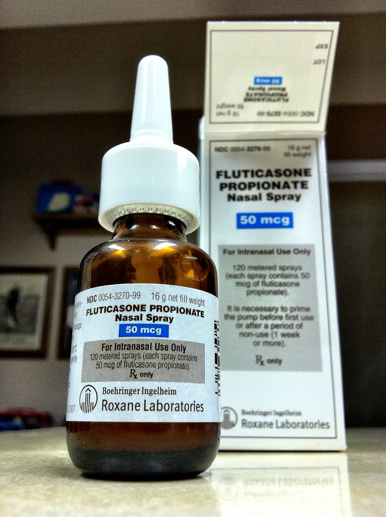 A bottle labelled as Fluticasone Propionate nasal spray.