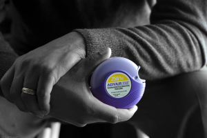 Photo of hand holding a AdVair brand powder inhaler