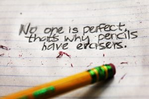 Words written in pencil on lined paper. The text reads: "No one is perfect. That's why pencils have erasers."