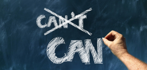A chalkboard with the word "can't" crossed out. The word "can" is written underneath.
