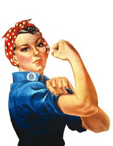 Rosie the Riveter. A white woman in work clothes and a bandana on her head. She flexes her right arm.