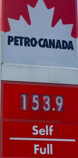 A price sign at a gas station with the number 153.9.