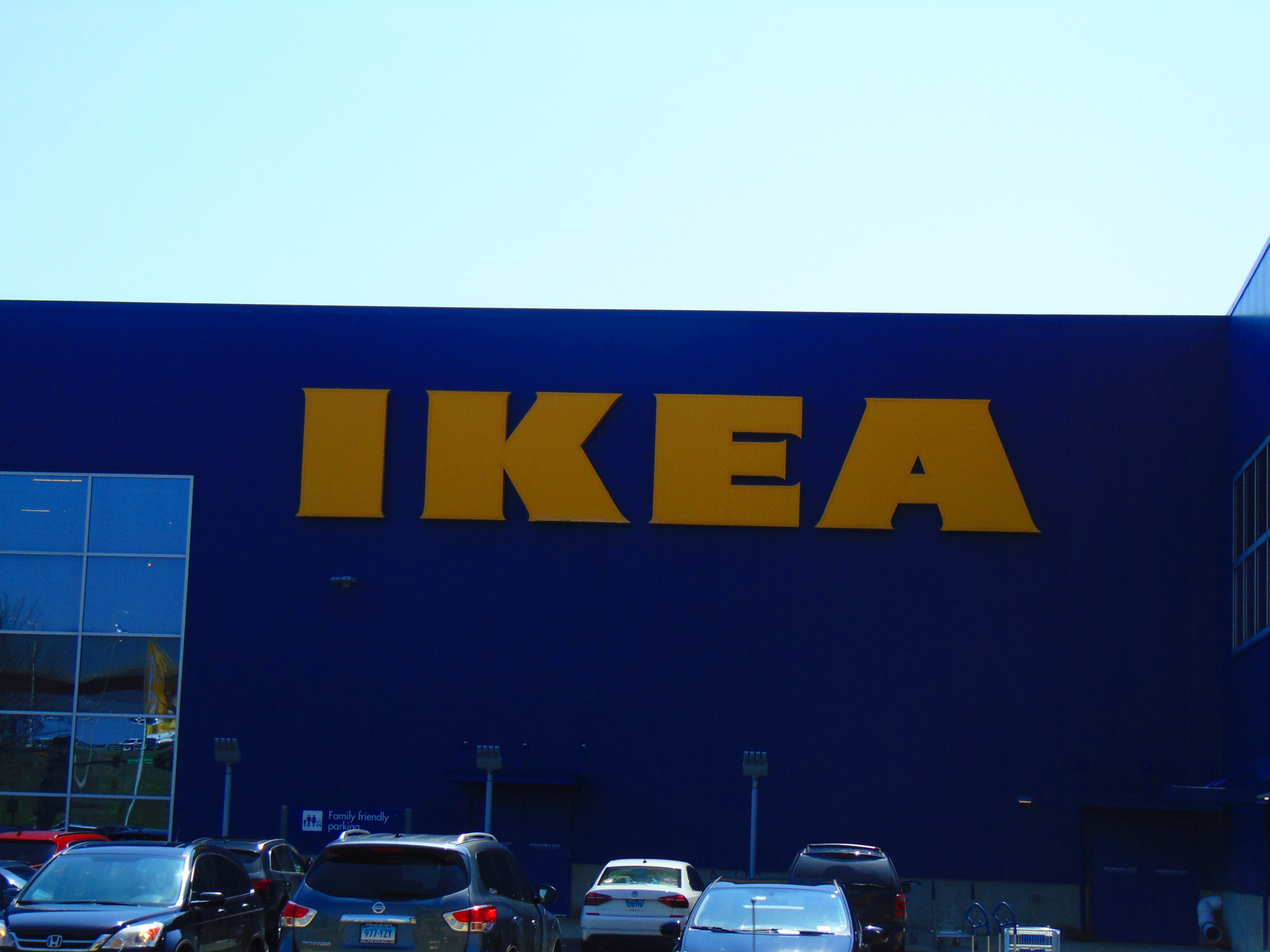 A photo shows a large Ikea building with cars parked beside it.