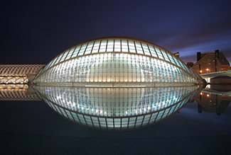 A picture of l'Hemisphèric, which is a giant glass structure that is in the shape of an ellipsoid.