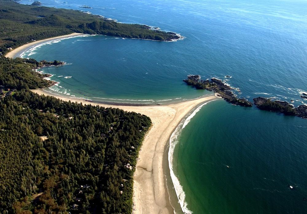 Figure 17.1 Chesterman Beach near Tofino on the west coast Vancouver Island. The strip of sediment connecting the main beach to the rocky island is a tombolo. [Photo by Todd Byrnes, used with permission of Chesterman Beach B and B] 