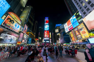 Times Square is lit up by billboards and advertisements