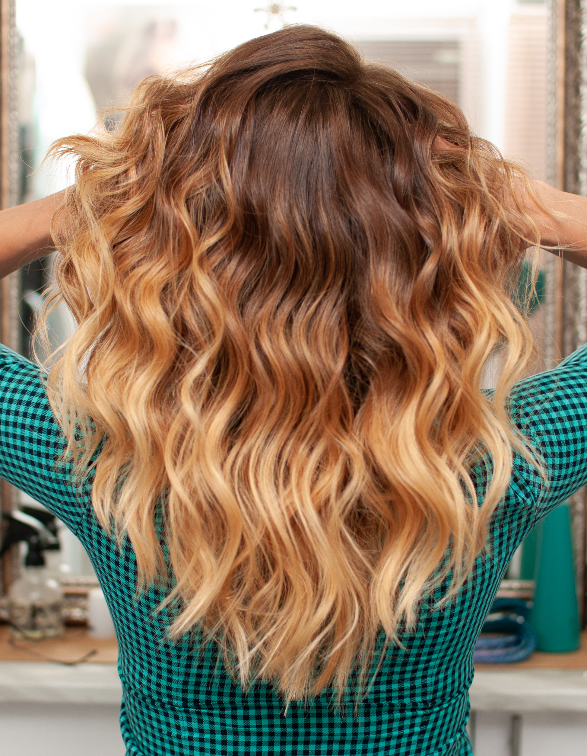 Ombré hair that transitions from brown, to auburn, to strawberry blonde.