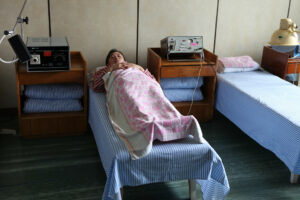 Woman in a hospital bed in maternity hospital, Pyongyang, North Korea.