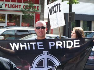 Skinhead displays White Pride flag in Kensington district of Calgary in 2007