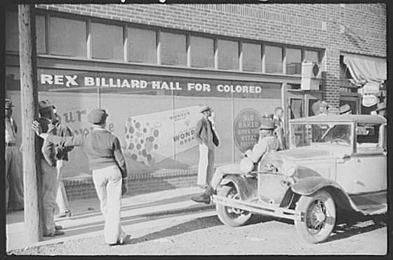 The store front of a billiard hall called, "Rex Billiard Hall for Colored"