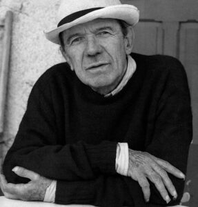 Photo of philosopher Gilles Deleuze arms folded, wearing a brimmed hat, facing the photographer