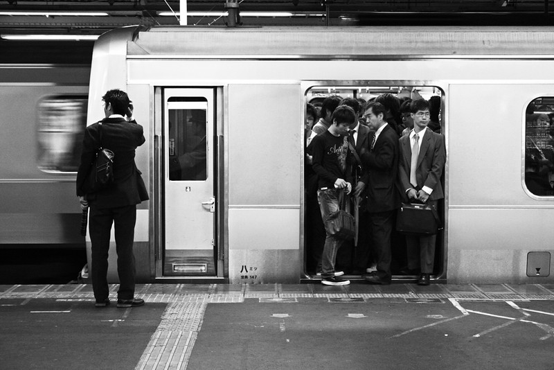 Crowded Tokyo subway car with doors open