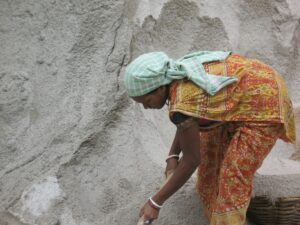 Indian woman digging sand