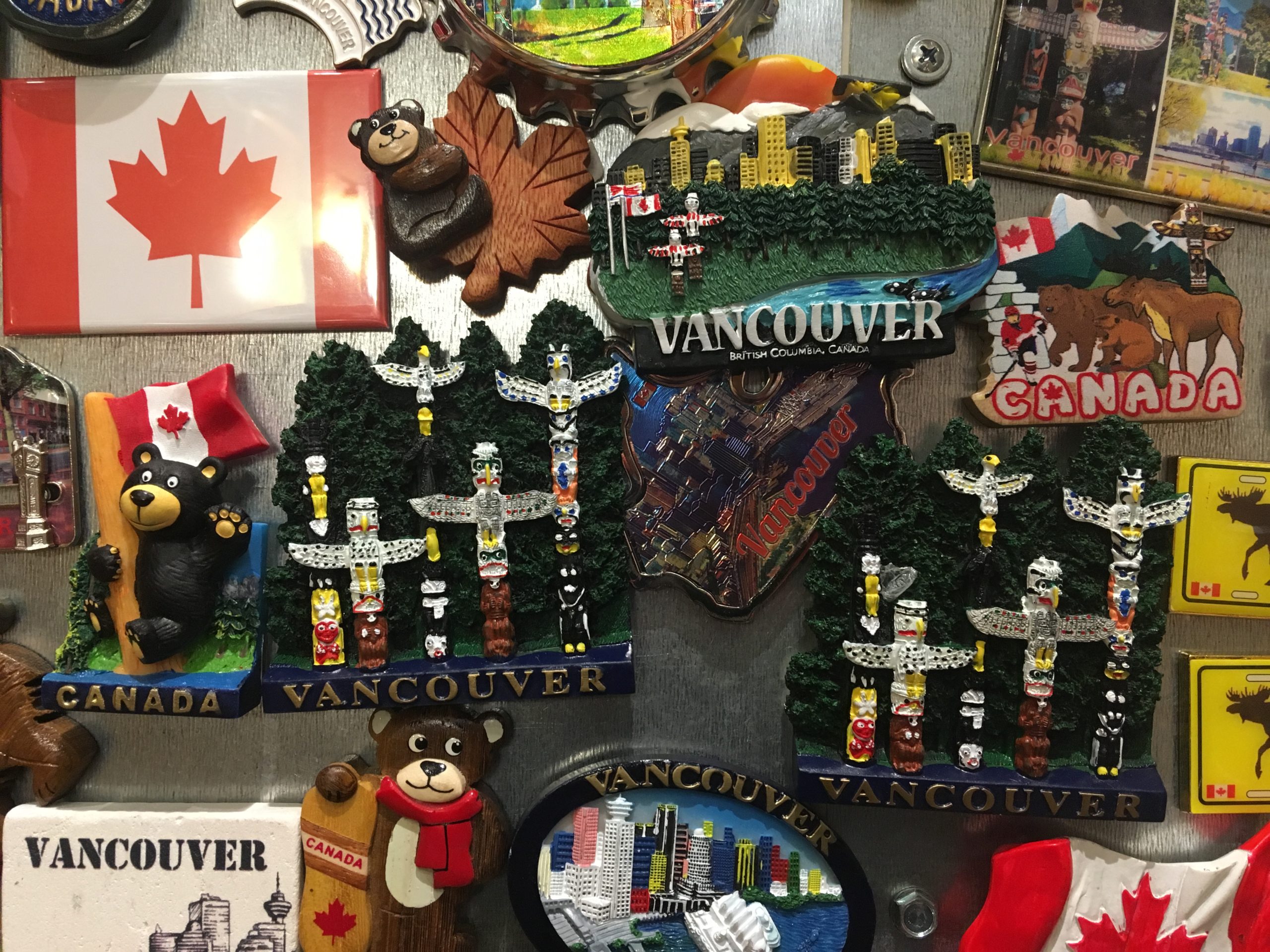 Photo of a souvenir shop’s Canadiana merchandise, which includes Canadian flags, black bears, and small totem pole replicas.