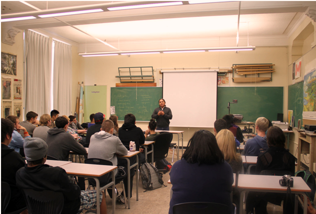 Figure 16.1. Film maker, Victor Masayesva, teaches about Hopi Indian culture in Aboriginal studies class at Point Grey Secondary, Vancouver. Schools teach us far more than reading, writing, and arthimetic. They also socialize us to cultural norms and expectations. (Photo courtesy of Victor Masayesva/flickr)