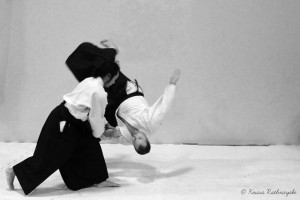 A girl throws her opponent to the ground.