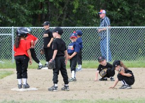 Young children playing baseball