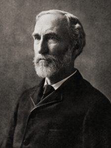 Portrait of a middle-aged man with a white beard.