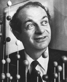 A smiling man surrounded by molecule models.
