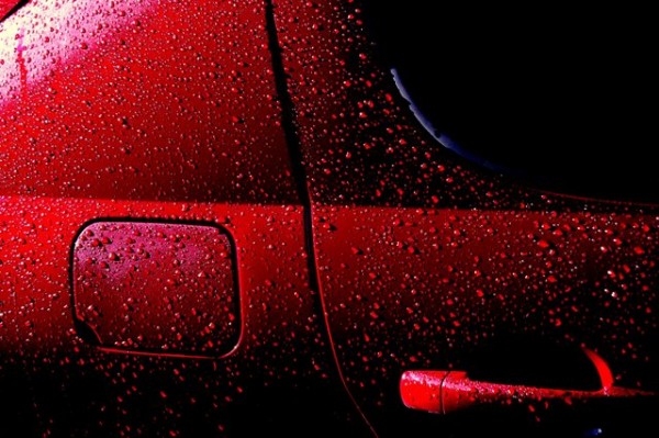 Droplets of water on a freshly waxed car do not wet the car well because of low adhesion between water and the waxed surface. This helps protect the car from rust. “Wet Red Car 1′′ by Rob Innes is licensed under the Creative Commons Attribution-NonCommercial-NoDerivs 2.0 Generic.