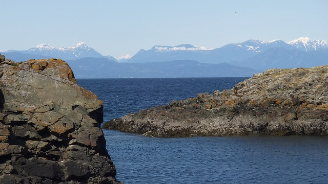 Moutains can be seen across the ocean.