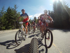 A line of bikers heading down a highway.