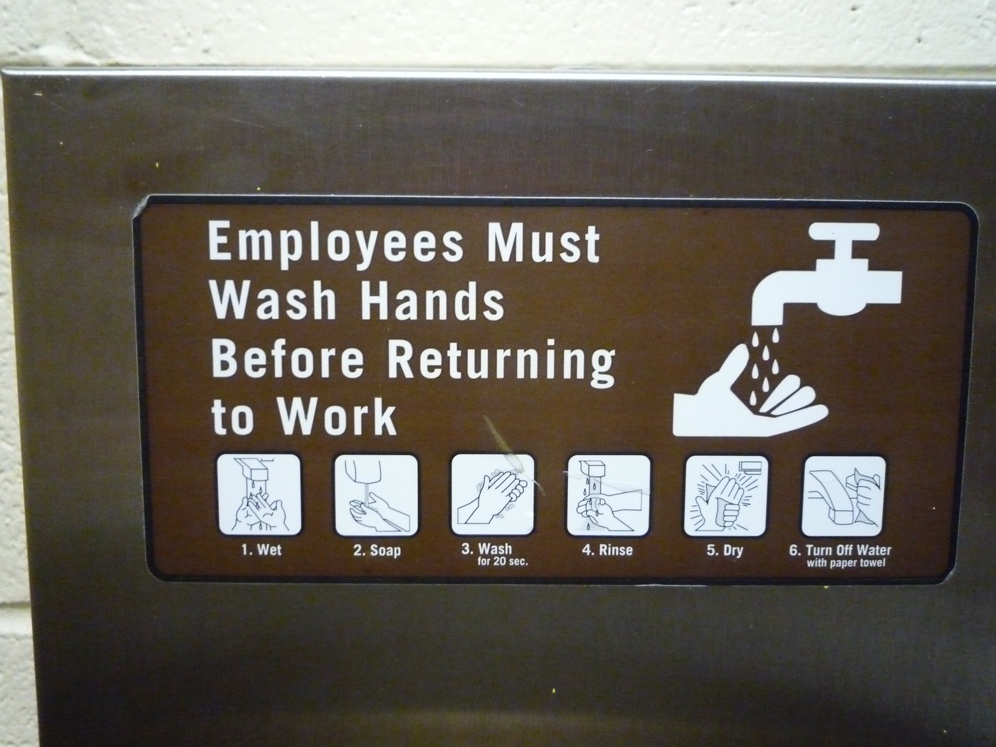 A sign describing proper hand washing, from wetting the hands to turning off the water.