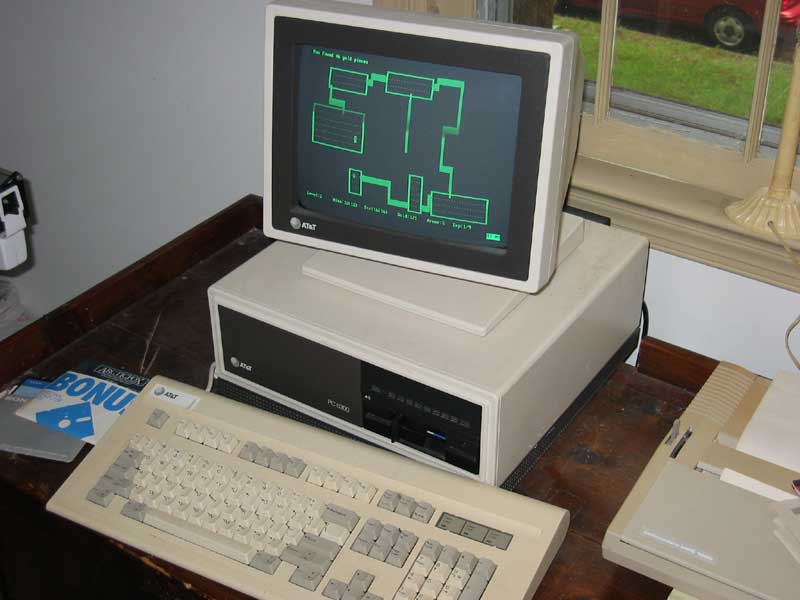 A chunky computer with a black and green screen.