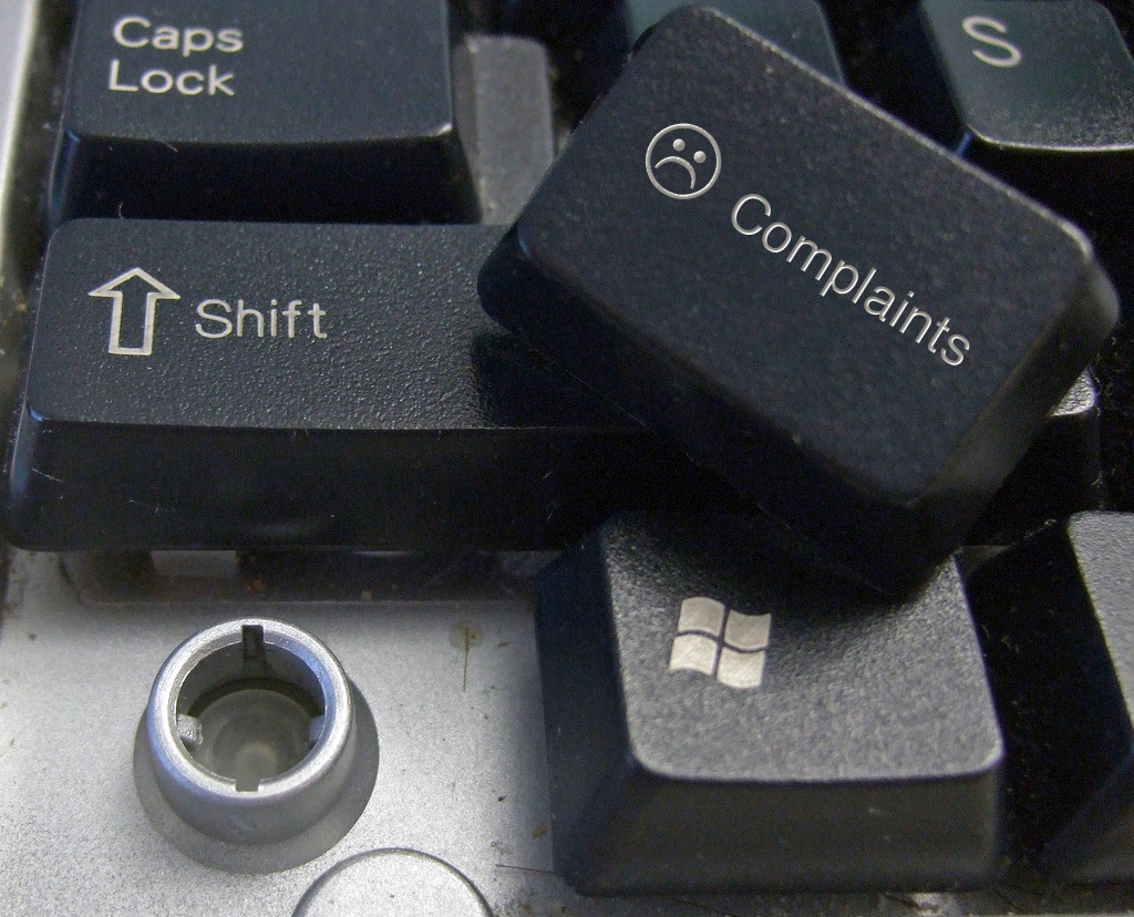 A keyboard with a removed key, which is marked with a sad face and the word "complaints."