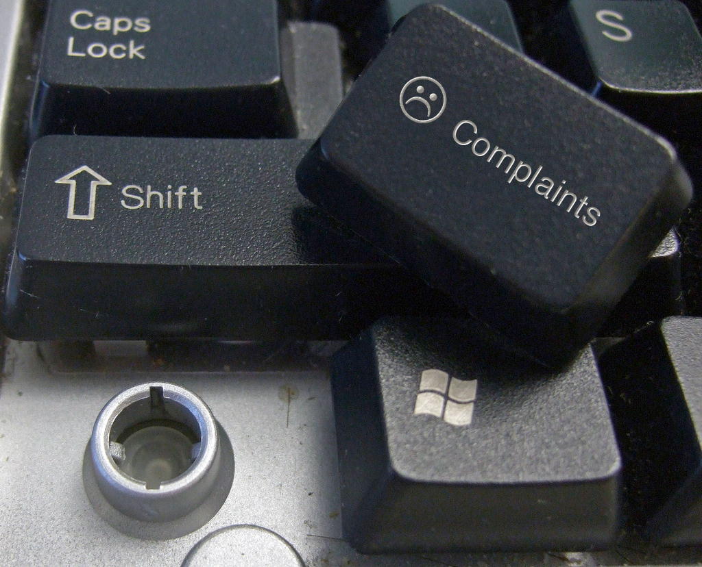 A keyboard with a removed key, which is marked with a sad face and the word &quot;complaints.&quot;